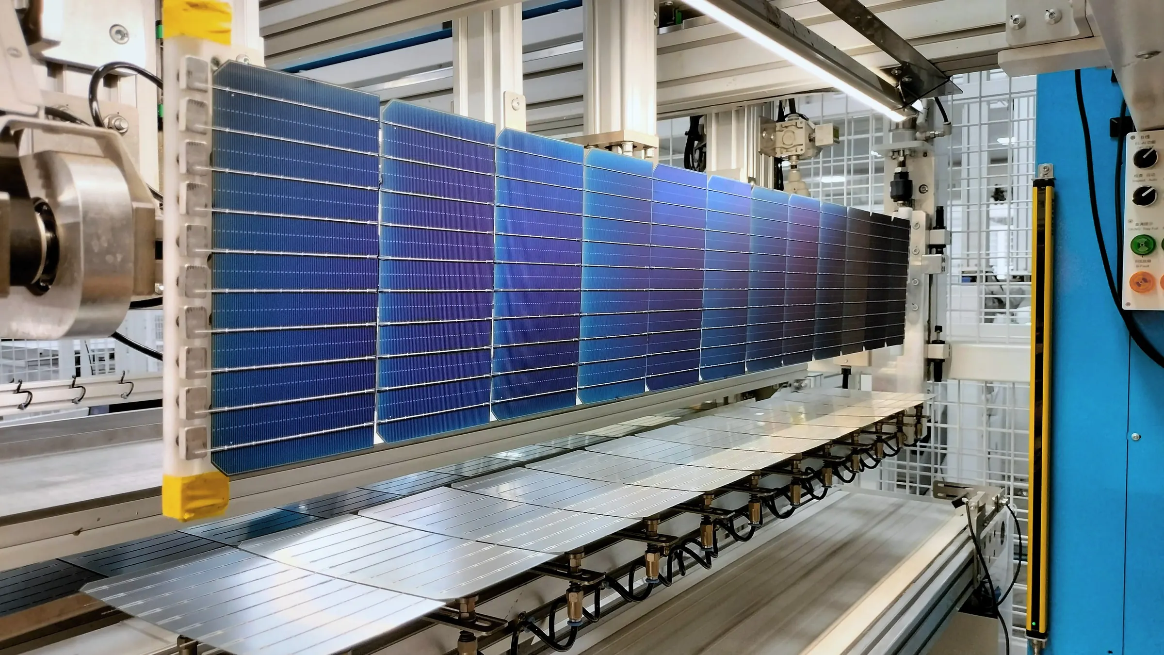 An interconnected string of solar cells on the stringer at Avco Power, Vapi